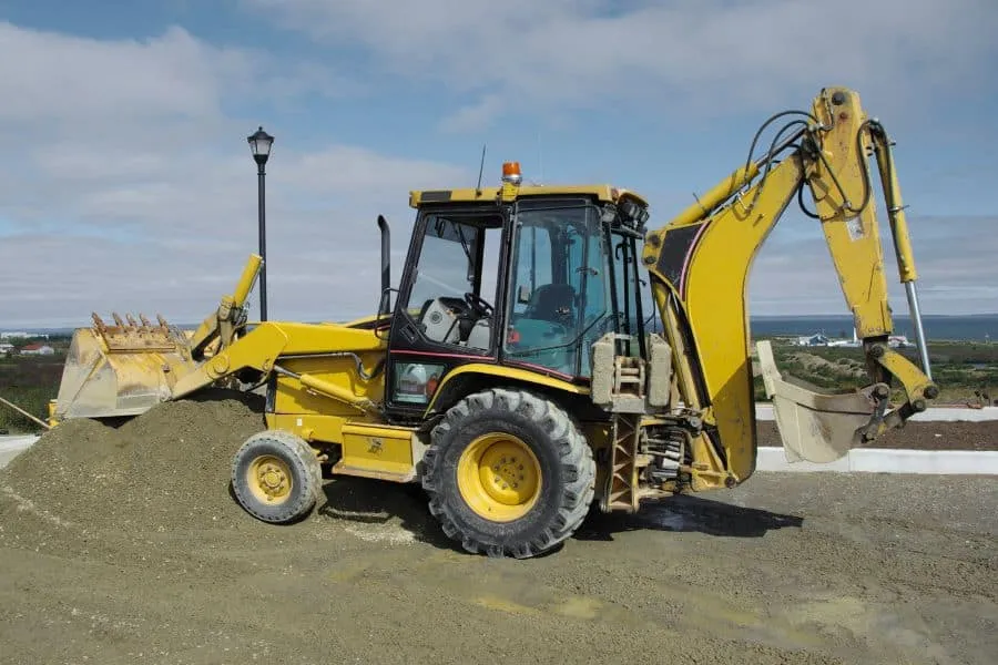 Backhoe using a Bucket to Push Dirt and Earth